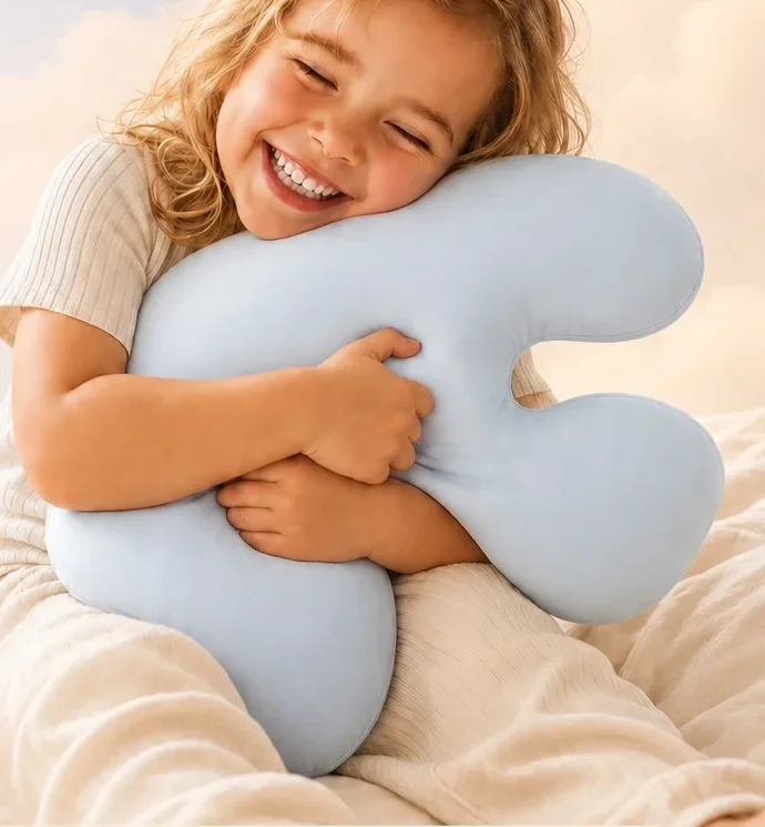 A girl hugging her Booney pillow, eyes closed with a big smile